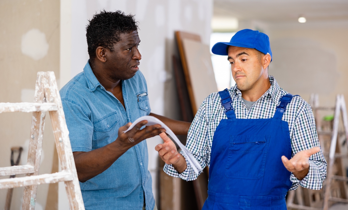 Disappointed owner of apartment talking to repairman