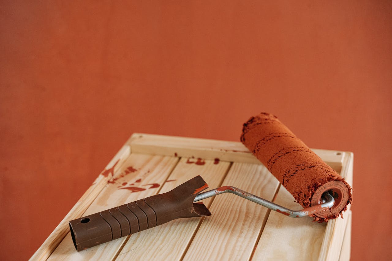 A Paint Roller on a Wooden Surface